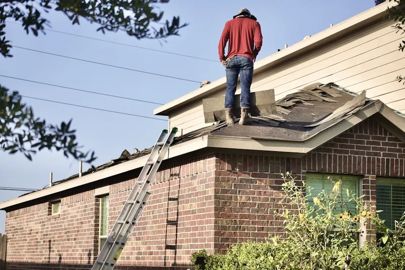 Professional roofer working on a residential roof in West Los Angeles